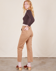 Angled back view of Work Pants in Tan and espresso brown Long Sleeve V-Neck Tee on Margaret