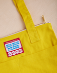 Over-Shoulder Zip Mini Tote in golden yellow close up detail top of bag
