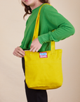 Over-Shoulder Zip Mini Tote in golden yellow worn by model