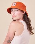 Big Bud Bucket Hat in burnt orange worn by Alex