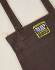 Over-Shoulder Zip Mini Tote in Espresso Brown close up with green Big Bud Press label