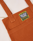 Over-Shoulder Zip Mini Tote in Burnt Terracotta close up with green Big Bud Press label
