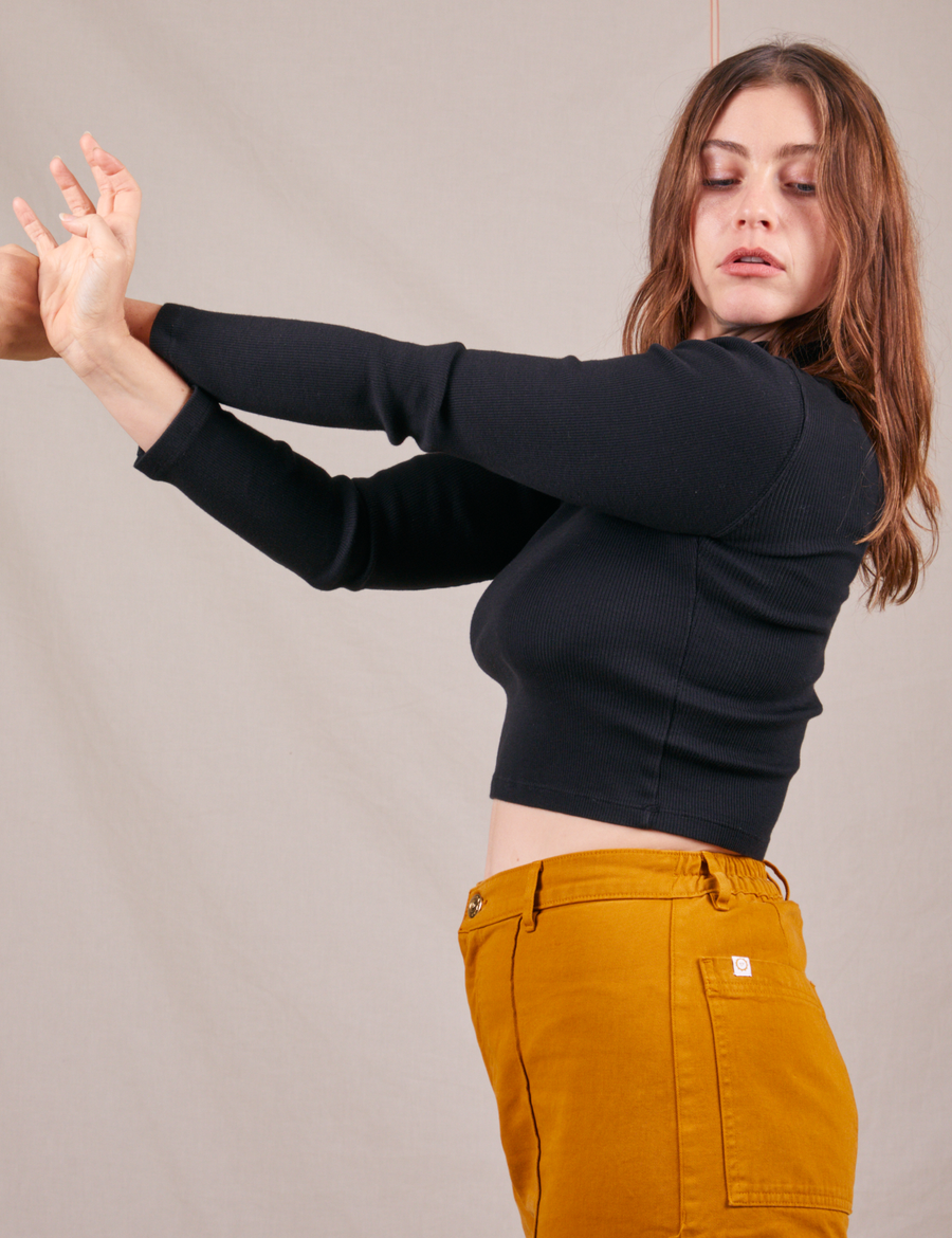 Side view of Essential Turtleneck in Basic Black worn by Allison