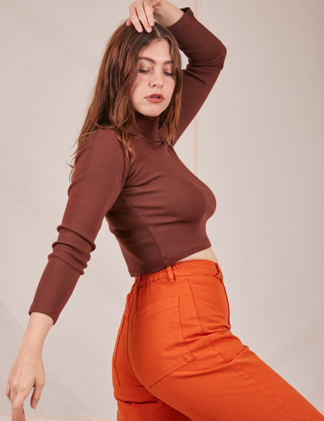 Side view of Essential Turtleneck in Fudgesicle Brown worn by Allison