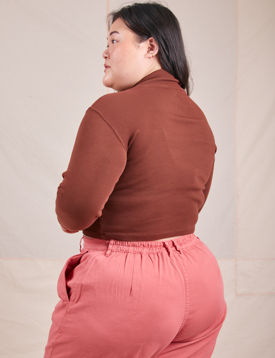 Angled back view of Essential Turtleneck in Fudgesicle Brown worn by Ashley