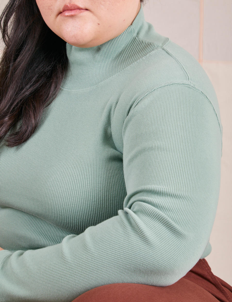 Close up of Essential Turtleneck in Sage Green on Ashley