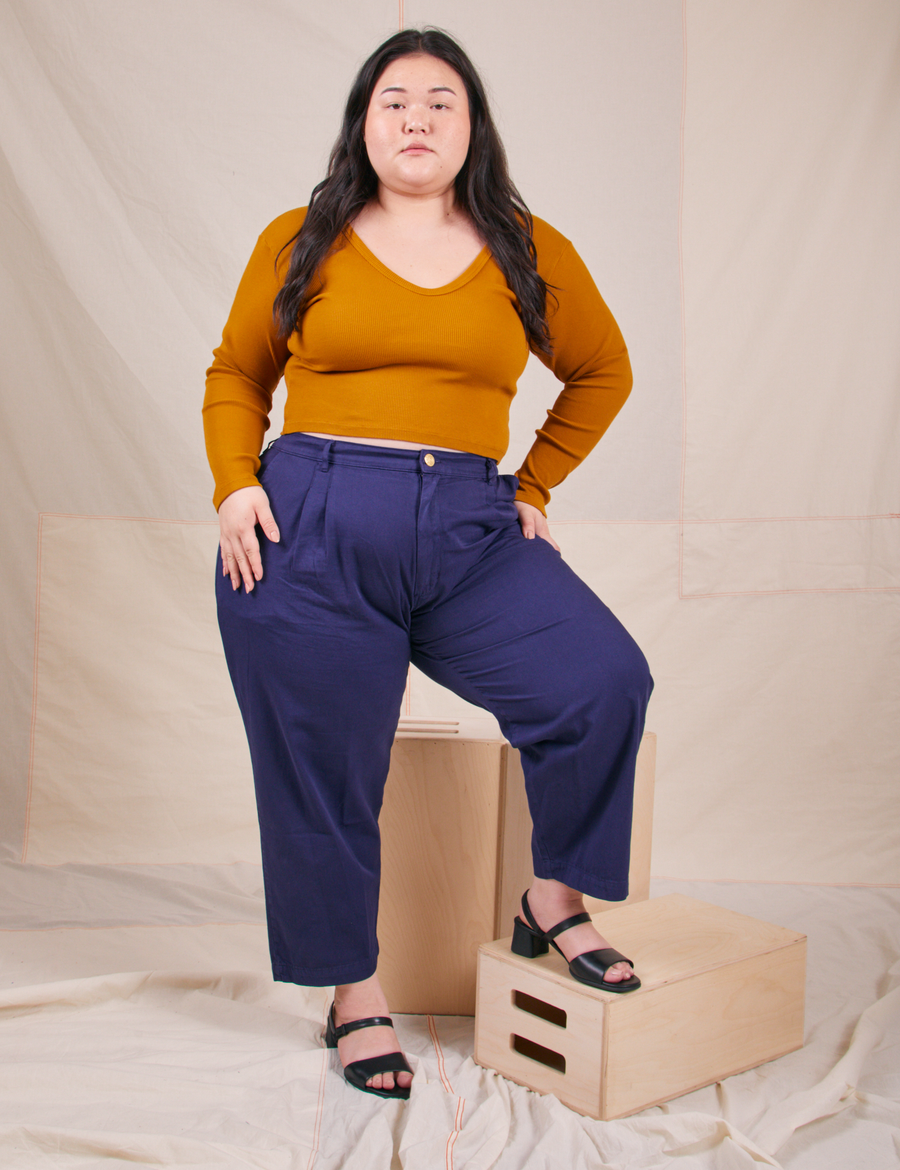 Long Sleeve V-Neck Tee in Spicy Mustard on Ashley wearing navy blue trousers