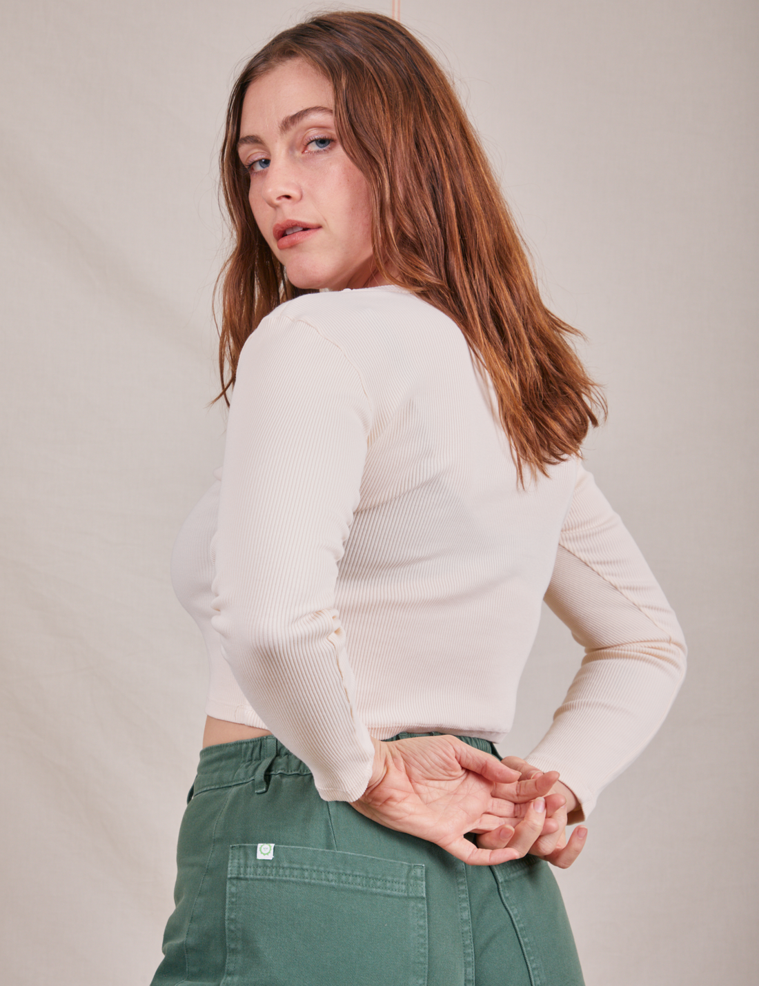 Angled back view of Long Sleeve V-Neck Tee in Vintage Tee Off-White worn by Allison