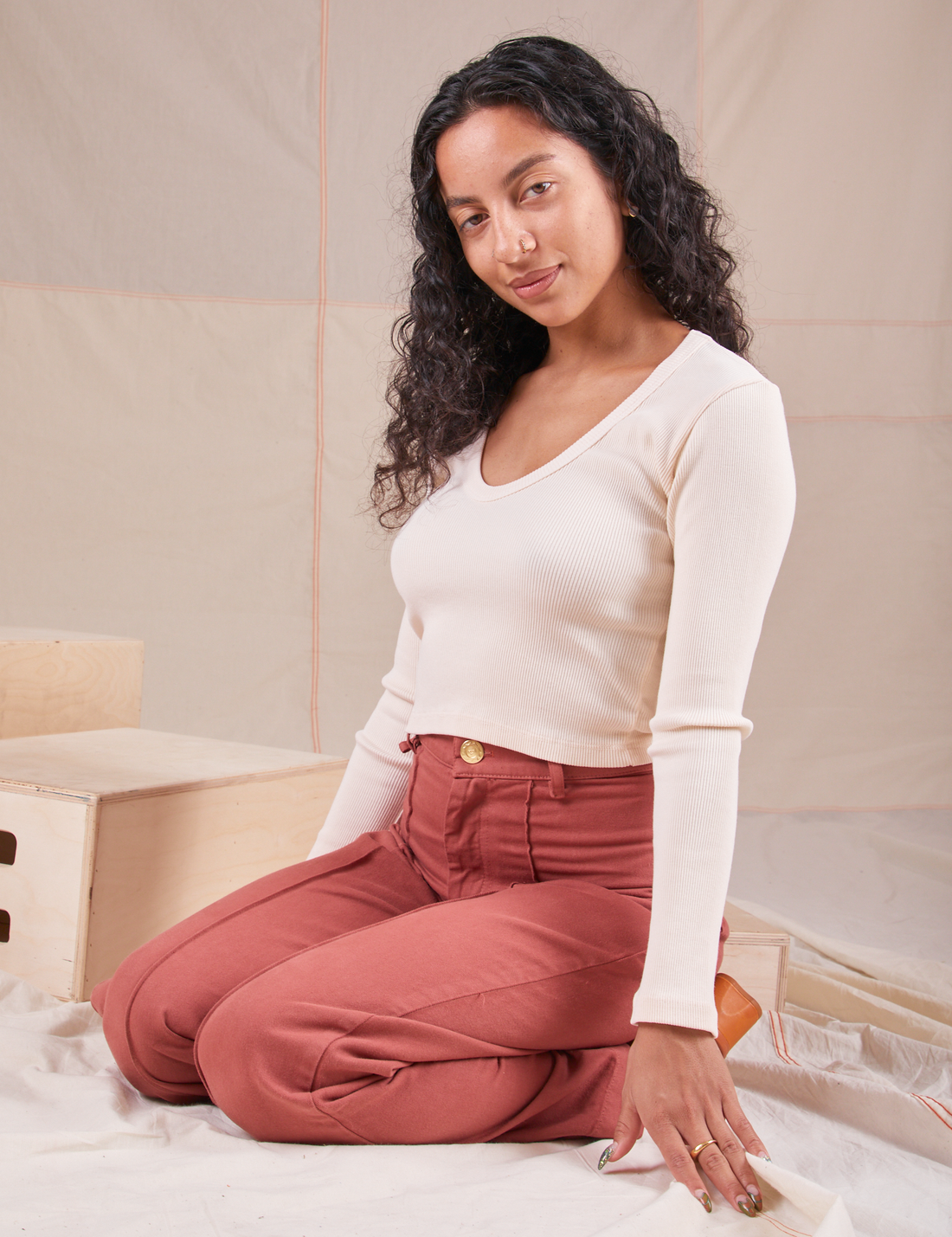 Blair is wearing Long Sleeve V-Neck Tee in Vintage Tee Off-White