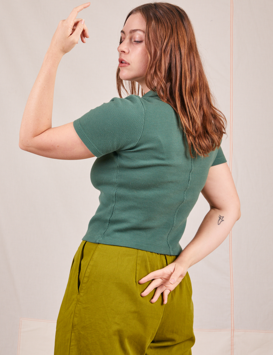 Back view of Fisherman Polo in Dark Emerald Green worn by Allison