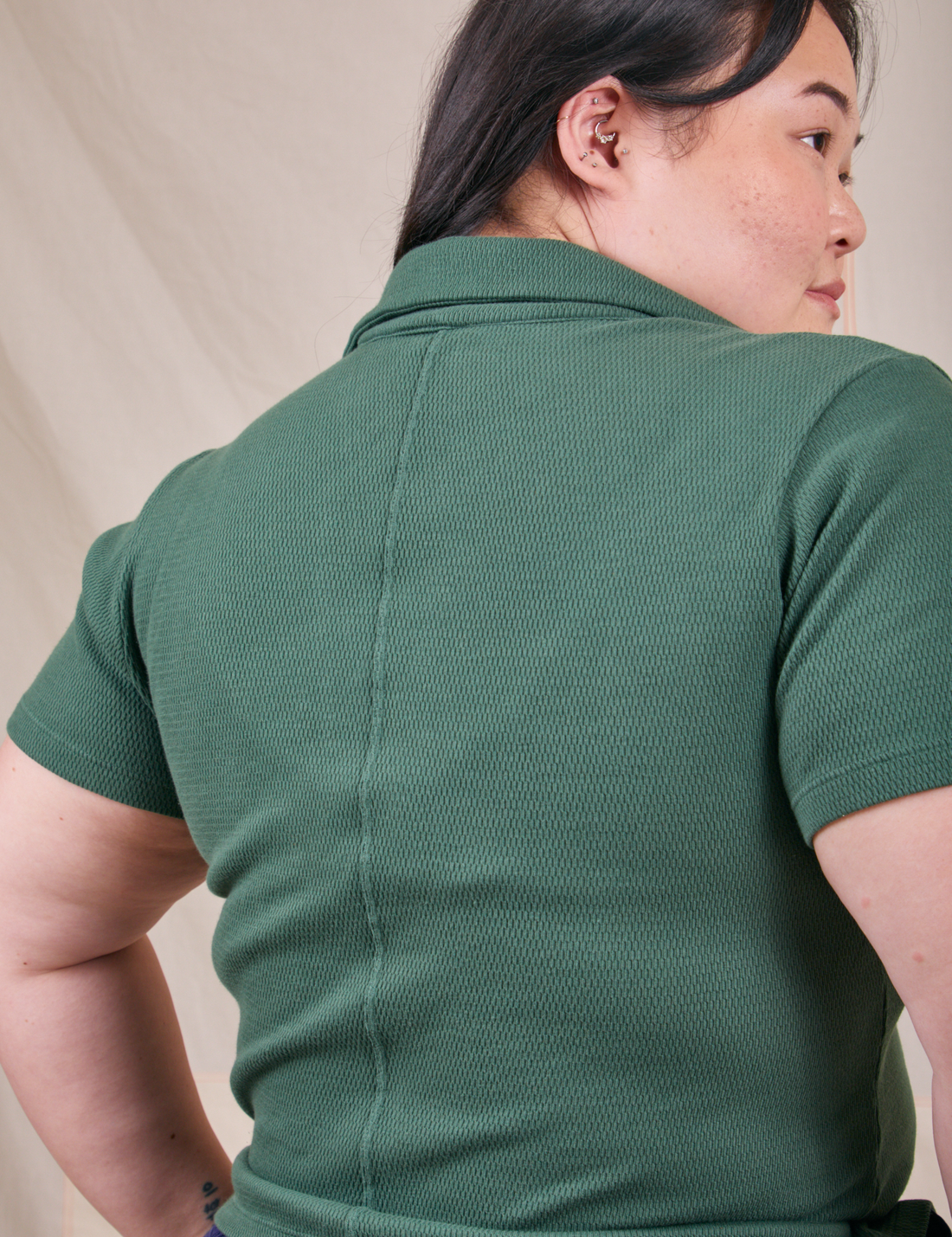 Back view of Fisherman Polo in Dark Emerald Green worn by Ashley