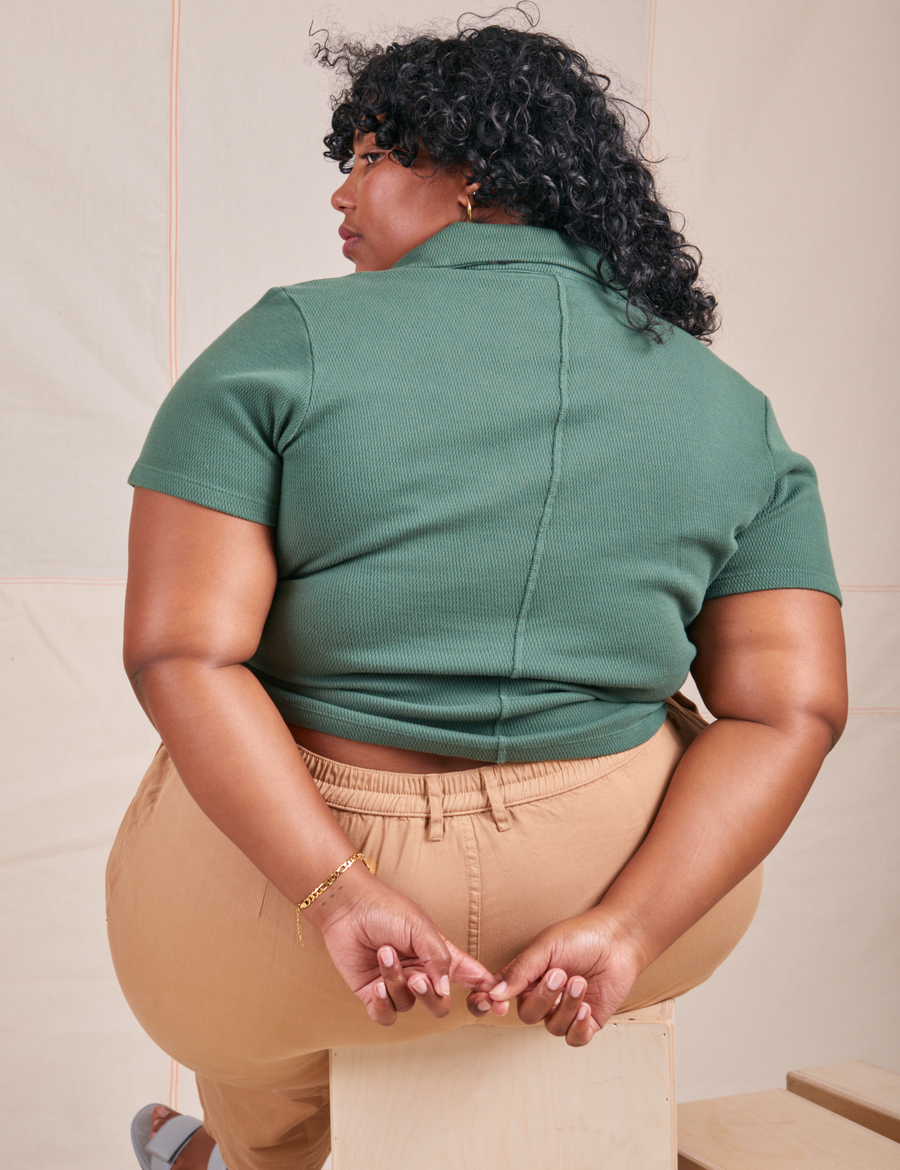 Back view of Fisherman Polo in Dark Emerald Green worn by Morgan
