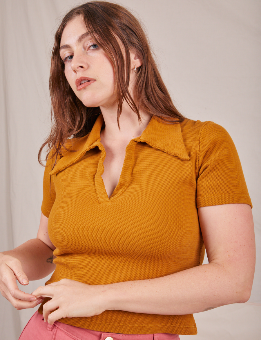 Allison is wearing XXS Fisherman Polo in Spicy Mustard