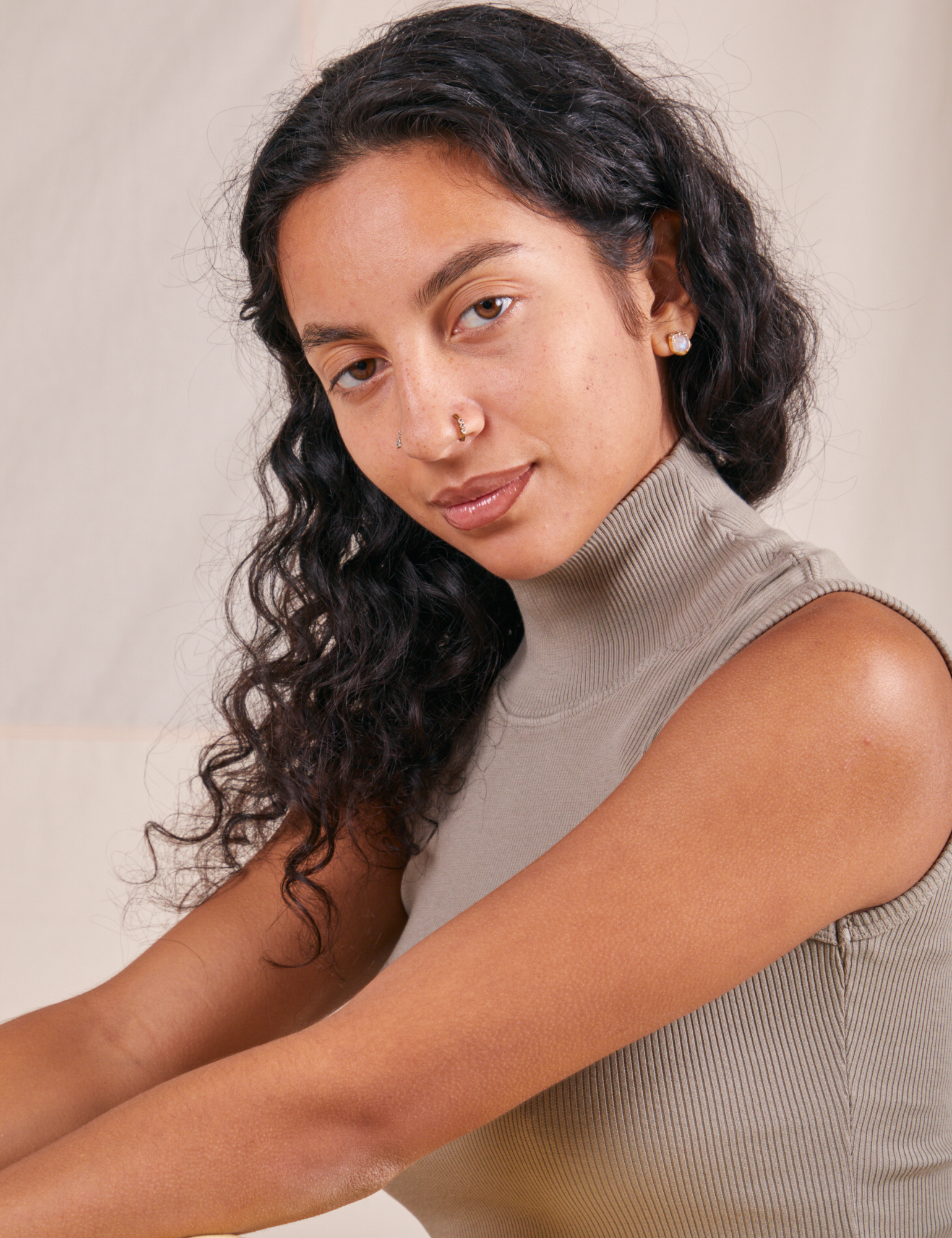 Front close up of Sleeveless Essential Turtleneck in Khaki Grey worn by Blair