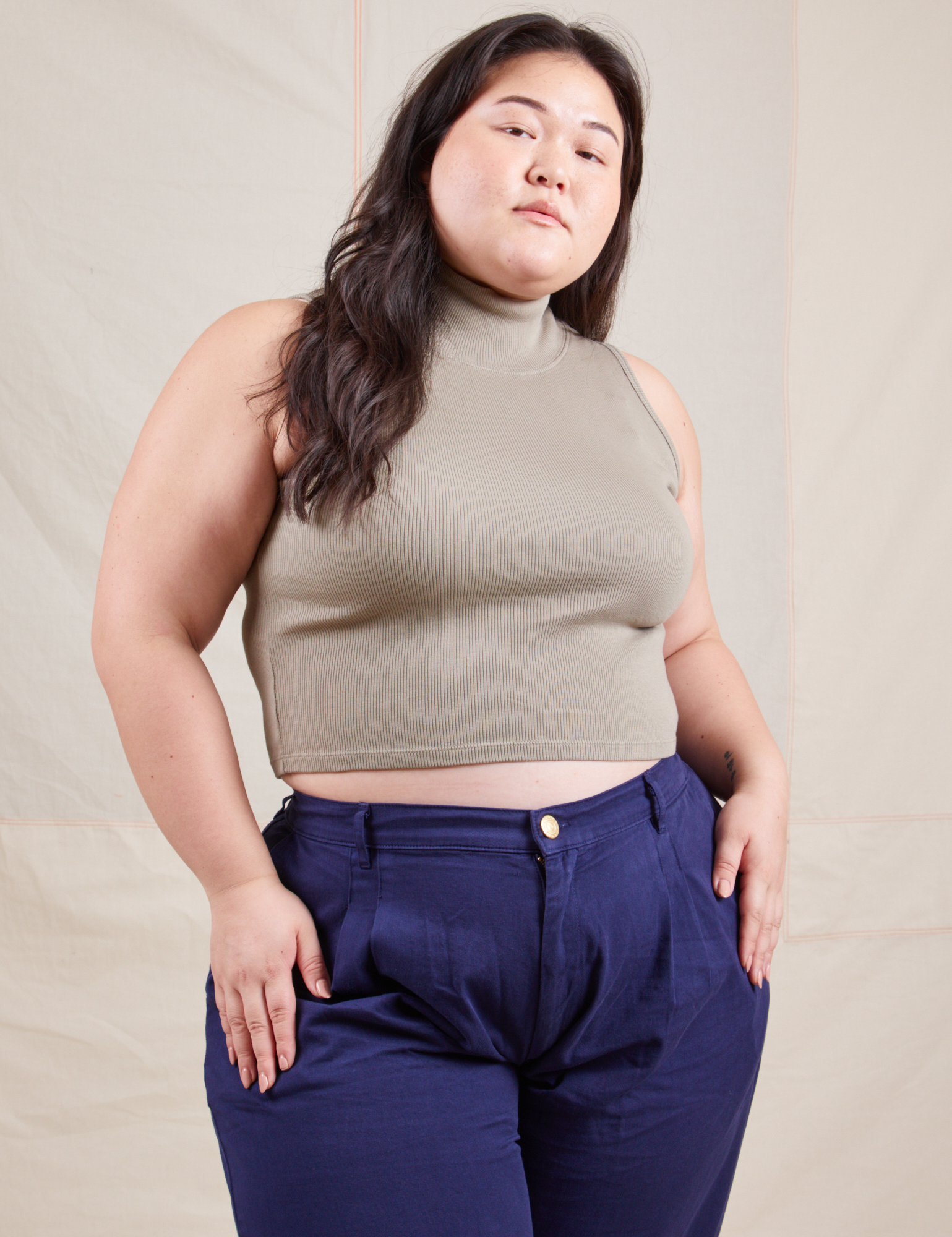 Ashley is wearing Sleeveless Essential Turtleneck in Khaki Grey