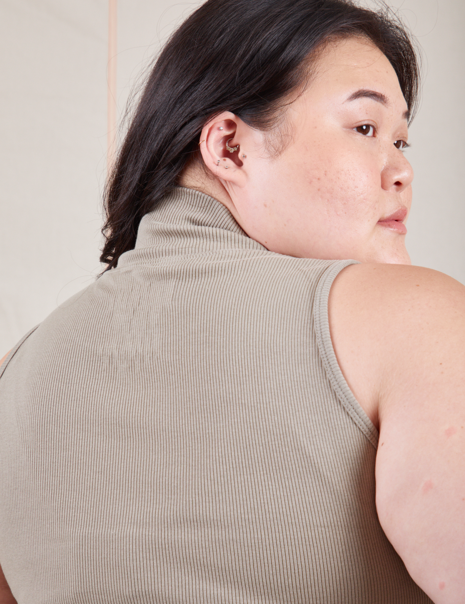 Back close up of Sleeveless Essential Turtleneck in Khaki Grey worn by Ashley