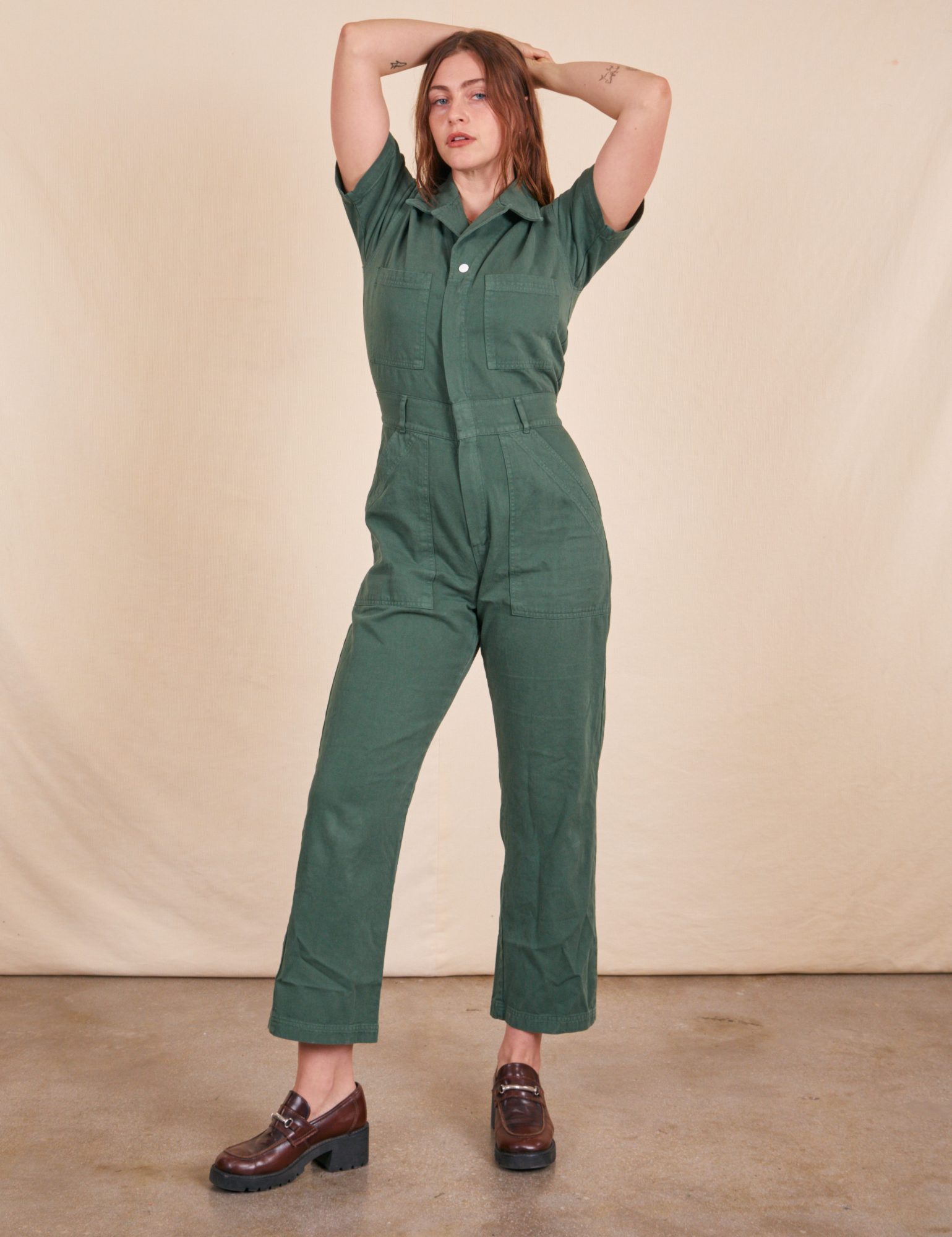 Allison is 5&#39;10&quot; and wearing S Short Sleeve Jumpsuit in Dark Emerald Green