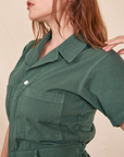Side view close up of Short Sleeve Jumpsuit in Dark Emerald Green worn by Allison