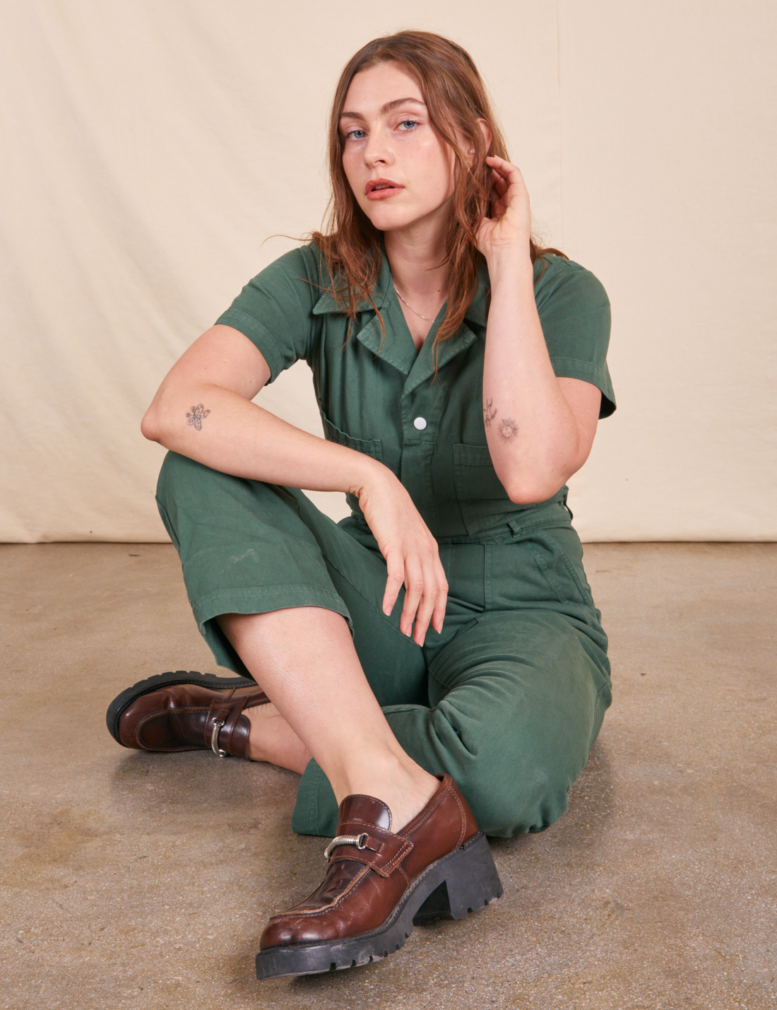Short Sleeve Jumpsuit in Dark Emerald Green on Allison sitting down