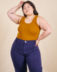 Ashley is wearing Tank Top in Spicy Mustard and navy Western Pants