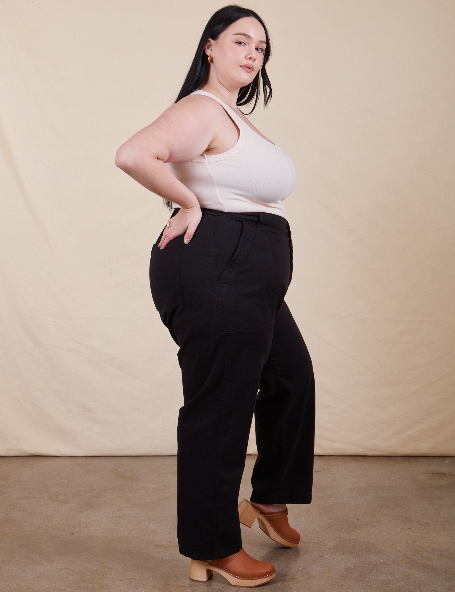 Side view of Work Pants in Basic Black and vintage off-white Tank Top on Kenna