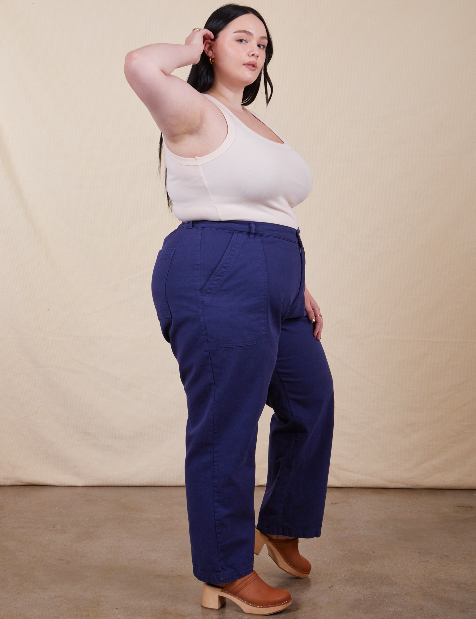Side view of Work Pants in Navy Blue and a vintage off-white Tank Top on Kenna