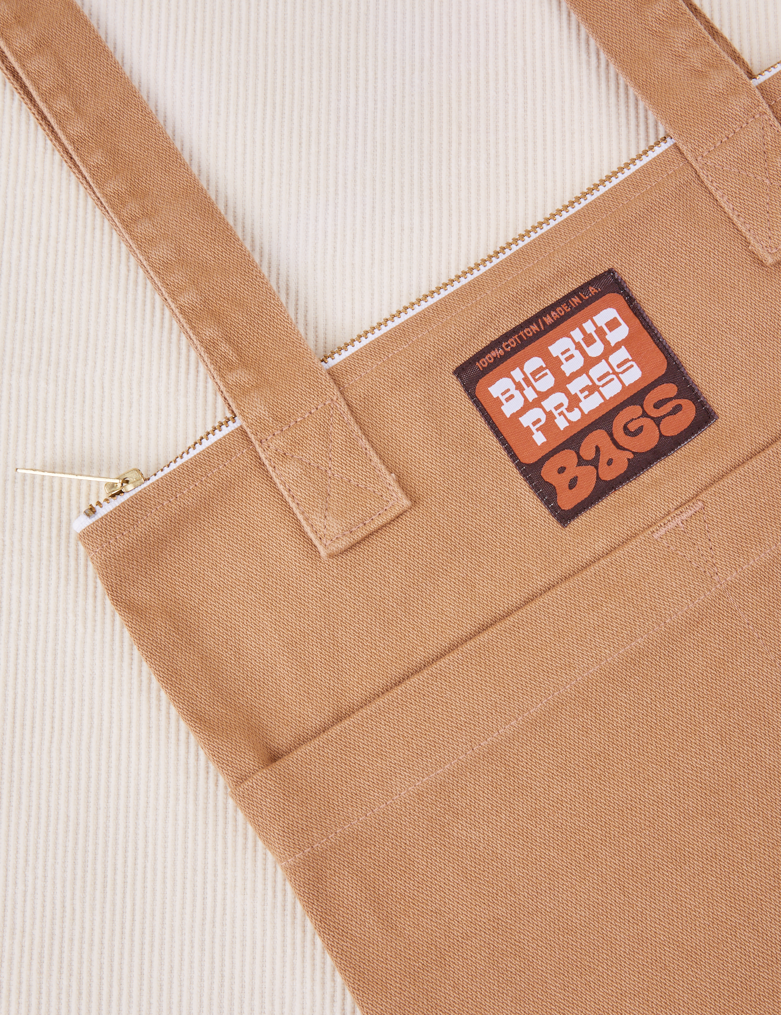 Over-Shoulder Zip Mini Tote in Tan close up with brown and orange Big Bud Press label