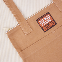 Over-Shoulder Zip Mini Tote in Tan close up with brown and orange Big Bud Press label